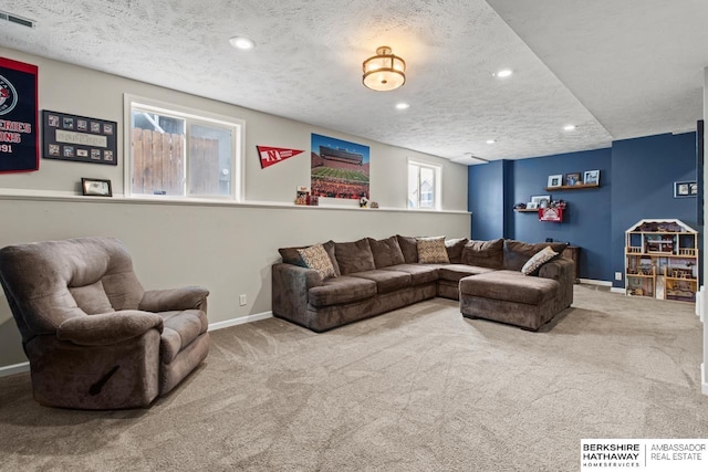 carpeted living room featuring a textured ceiling