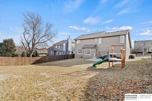 back of property featuring a playground