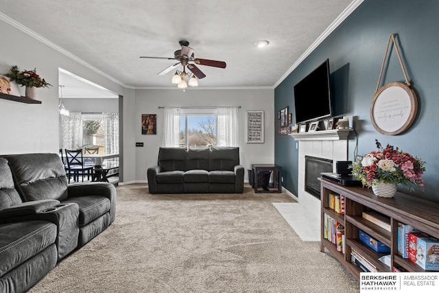 carpeted living room with crown molding, a tile fireplace, and a healthy amount of sunlight