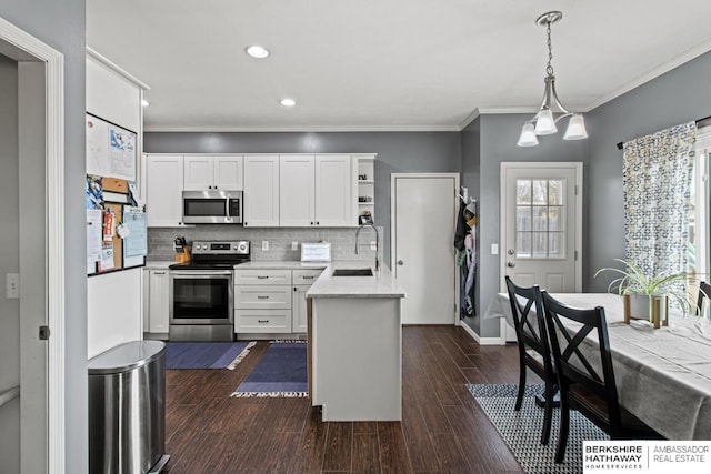 kitchen featuring white cabinetry, dark hardwood / wood-style floors, appliances with stainless steel finishes, and decorative light fixtures