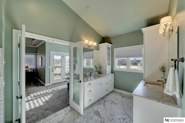 bathroom with vanity, plenty of natural light, and high vaulted ceiling