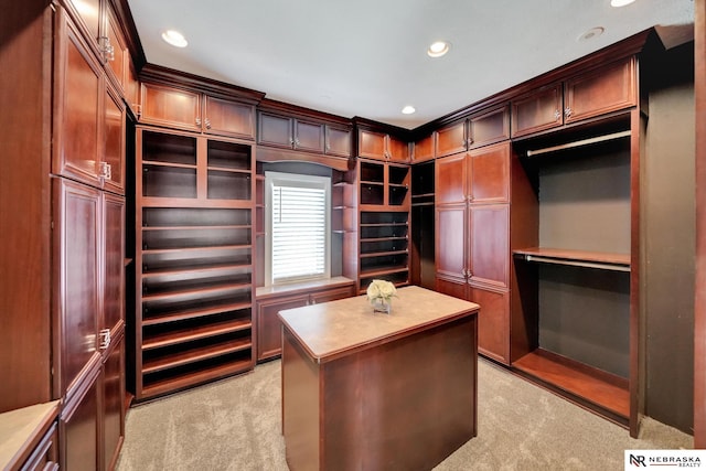 walk in closet featuring light colored carpet