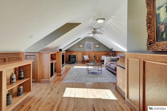 interior space with ceiling fan, vaulted ceiling, and light hardwood / wood-style flooring