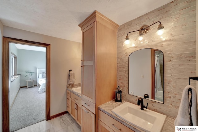 bathroom featuring vanity, a textured ceiling, and rustic walls