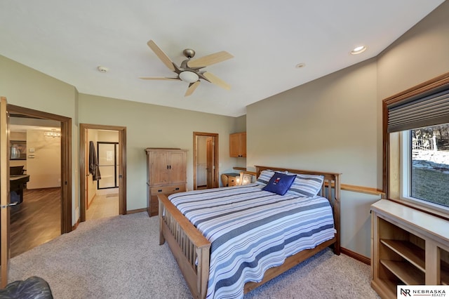 carpeted bedroom with connected bathroom and ceiling fan