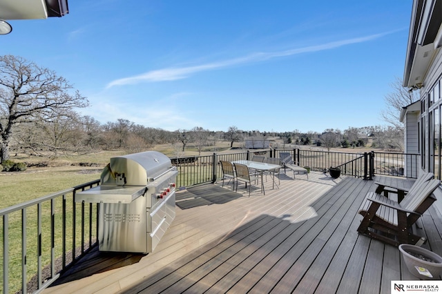 wooden terrace featuring a yard