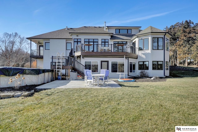 rear view of property with a pool side deck, a yard, and a patio area