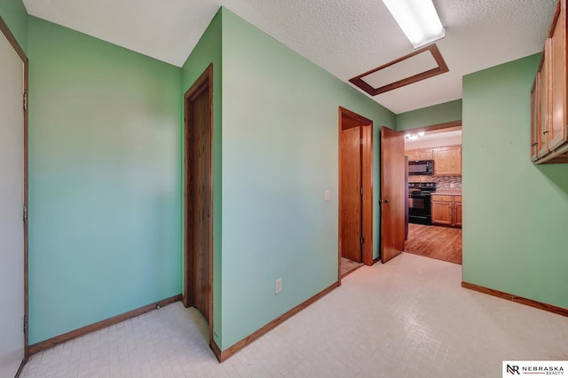 hall featuring a textured ceiling