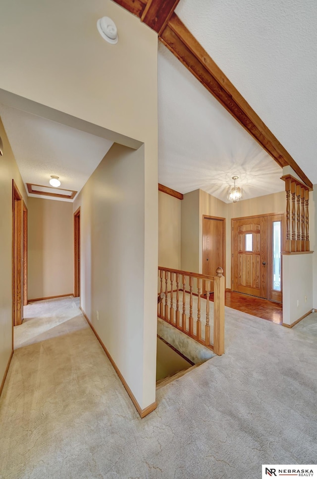 corridor with light carpet and beam ceiling