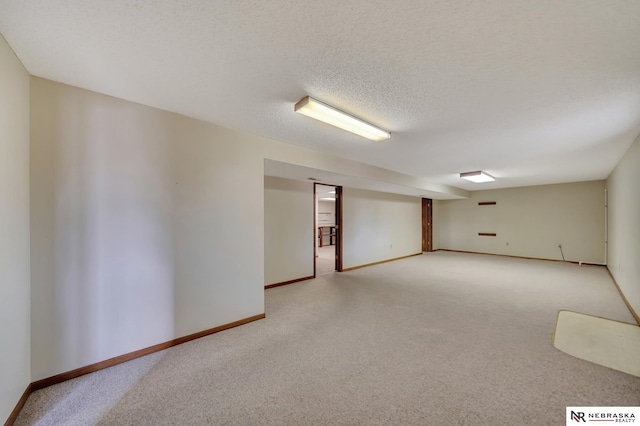 unfurnished room with light carpet and a textured ceiling