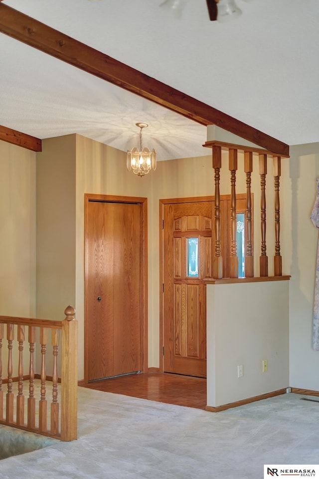 entrance foyer with a notable chandelier and beam ceiling