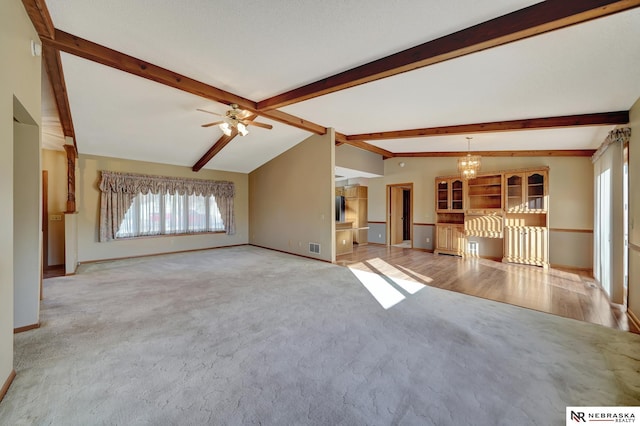 unfurnished living room featuring ceiling fan with notable chandelier, light colored carpet, and lofted ceiling with beams