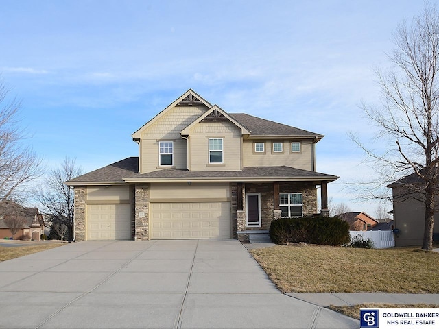 view of front of property featuring a garage and a front lawn