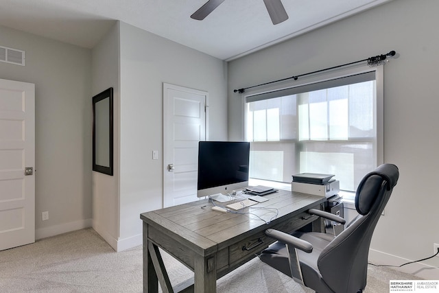 office space with ceiling fan and light carpet