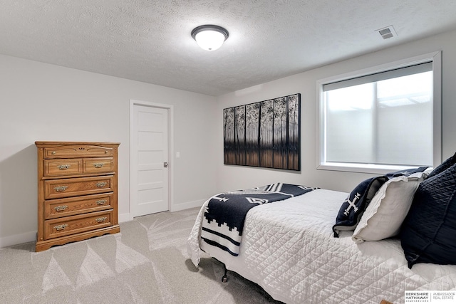 carpeted bedroom with a textured ceiling