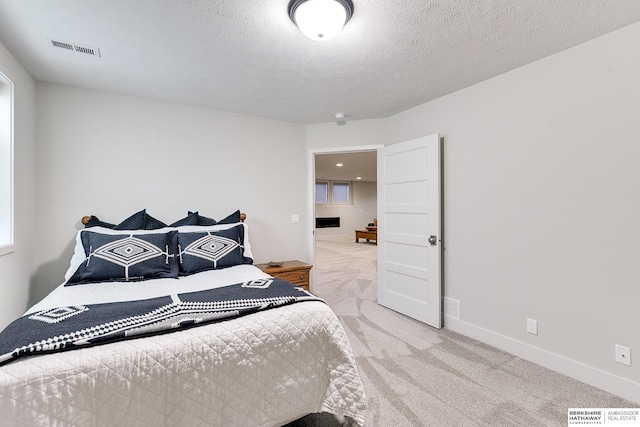 carpeted bedroom featuring a textured ceiling