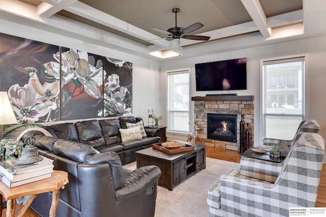 living room with beamed ceiling, ceiling fan, coffered ceiling, and a fireplace