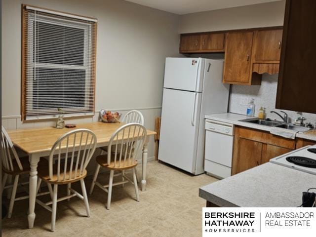 kitchen with sink and white appliances