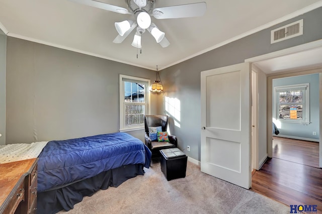 bedroom with crown molding, ceiling fan, and carpet flooring