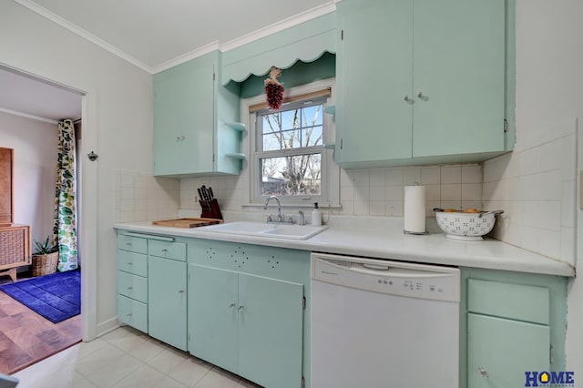 kitchen with tasteful backsplash, dishwasher, sink, light tile patterned floors, and crown molding