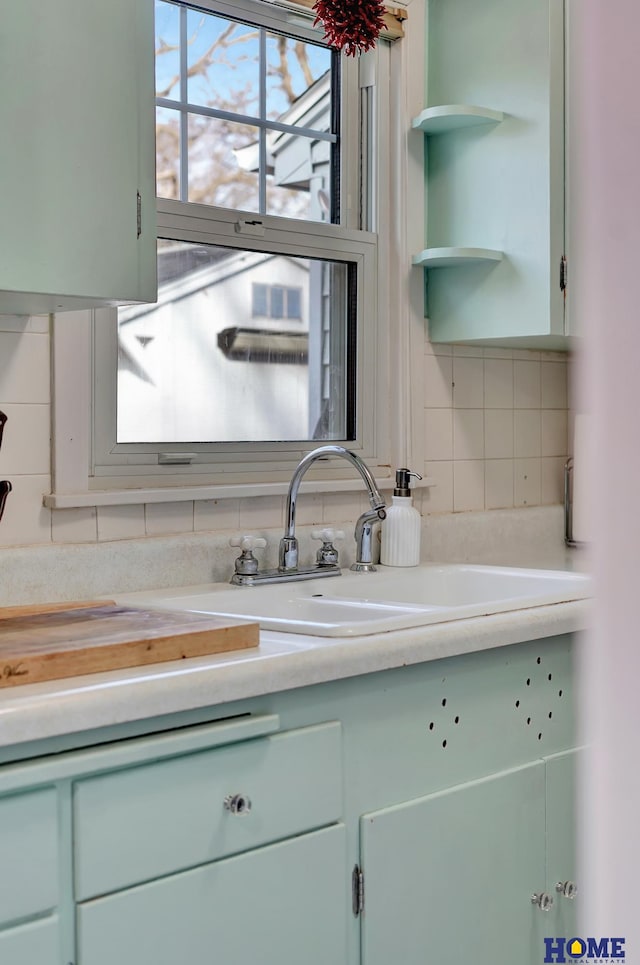 kitchen featuring plenty of natural light, sink, and backsplash