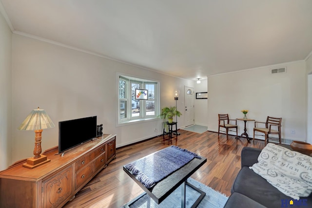 living room featuring wood-type flooring and ornamental molding