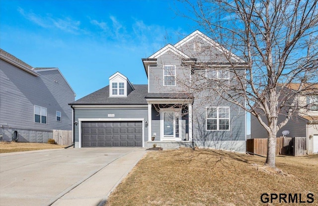 front of property with a garage and a front lawn