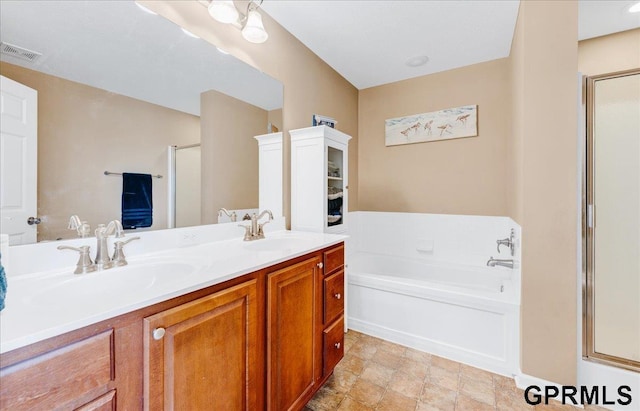 bathroom with vanity and separate shower and tub