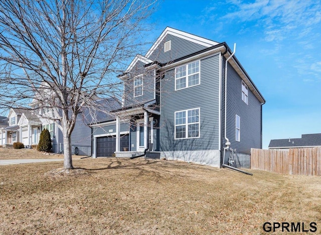 view of front property with a garage and a front yard