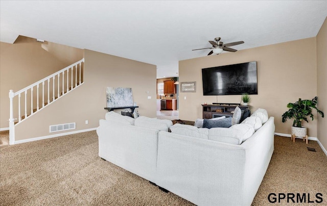 living room with ceiling fan and carpet floors