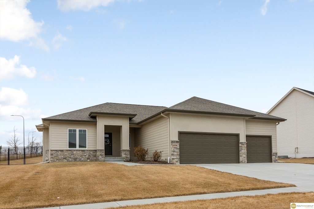 prairie-style house with a garage and a front yard