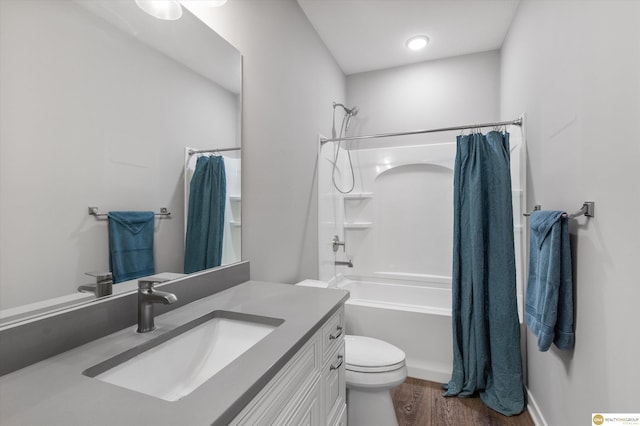 full bathroom with shower / tub combo, vanity, wood-type flooring, and toilet