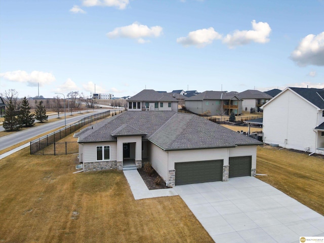 view of front of house with a garage and a front yard