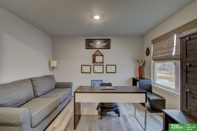 home office with light hardwood / wood-style floors