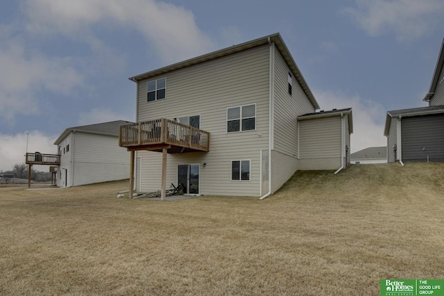 rear view of property featuring a wooden deck and a yard