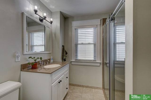 bathroom featuring vanity, tile patterned flooring, a shower with door, and toilet