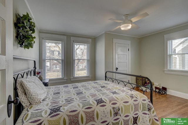 bedroom featuring crown molding, ceiling fan, and hardwood / wood-style floors