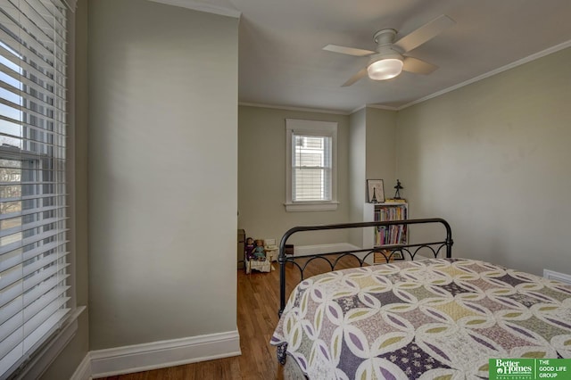 bedroom with hardwood / wood-style floors, ornamental molding, and ceiling fan