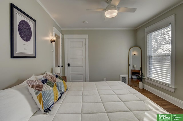 bedroom featuring crown molding, hardwood / wood-style floors, and ceiling fan