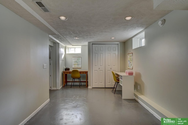 basement featuring a textured ceiling