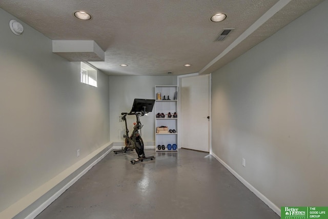 exercise room with a textured ceiling