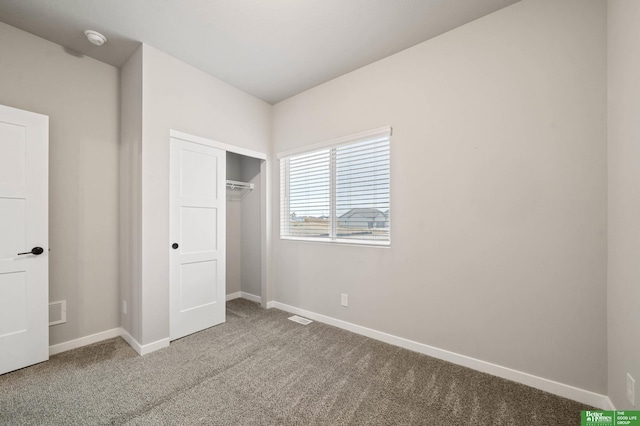 unfurnished bedroom with carpet flooring and a closet