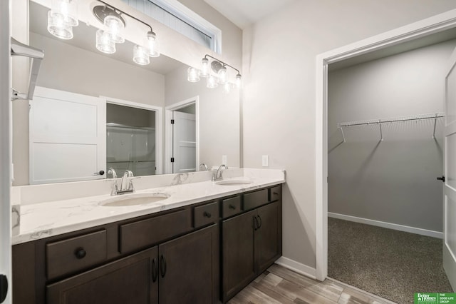 bathroom featuring vanity, hardwood / wood-style flooring, and a shower with shower door