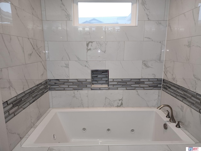 bathroom featuring tiled tub