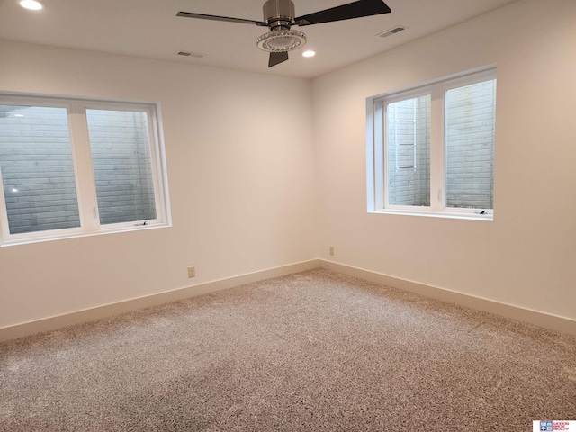 unfurnished room featuring ceiling fan and carpet flooring