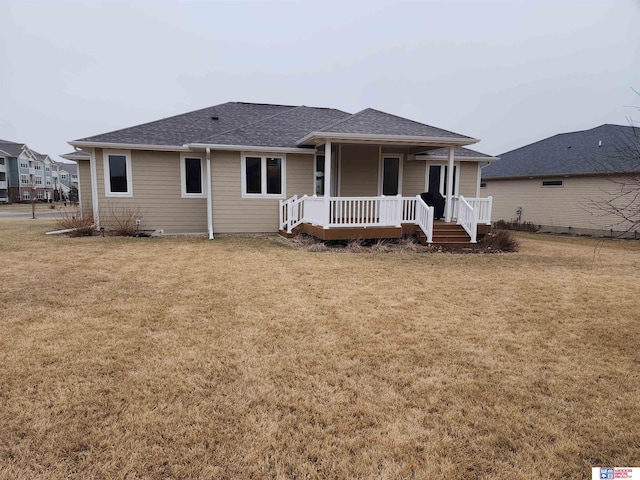 view of front of property with a front yard and covered porch