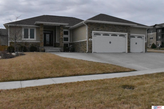 view of front facade with a garage and a front lawn