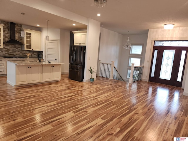 interior space with a notable chandelier and light hardwood / wood-style floors