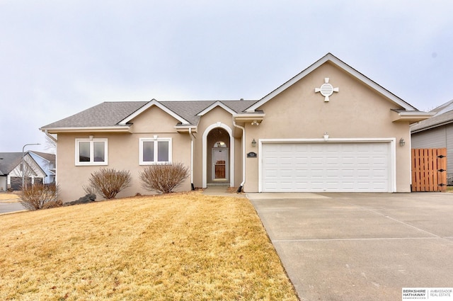 single story home with a garage and a front yard