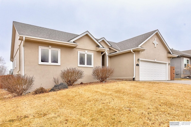 view of front of home with a garage and a front lawn